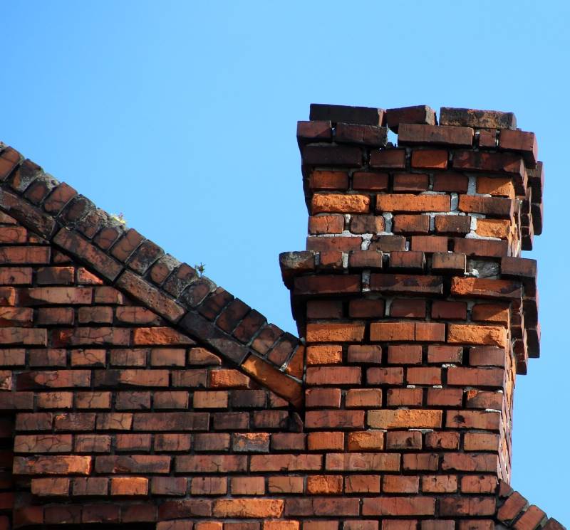 Damaged chimney on an Beltsville home showing cracks and missing mortar